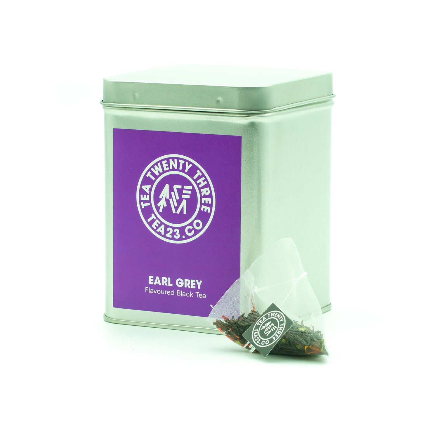 An Earl Grey tea bag next to a silver tin with a purple label