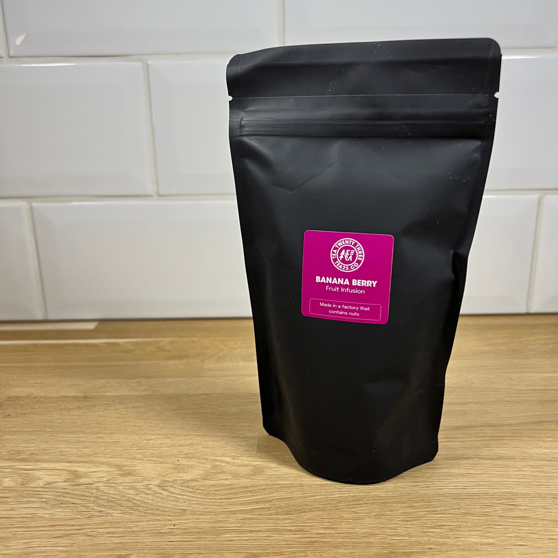 A black pouch of Banana Berry fruit tea on a table