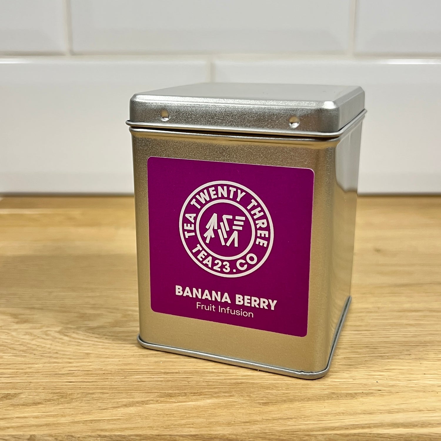 A silver gift tin of loose leaf Banana Berry fruit tea