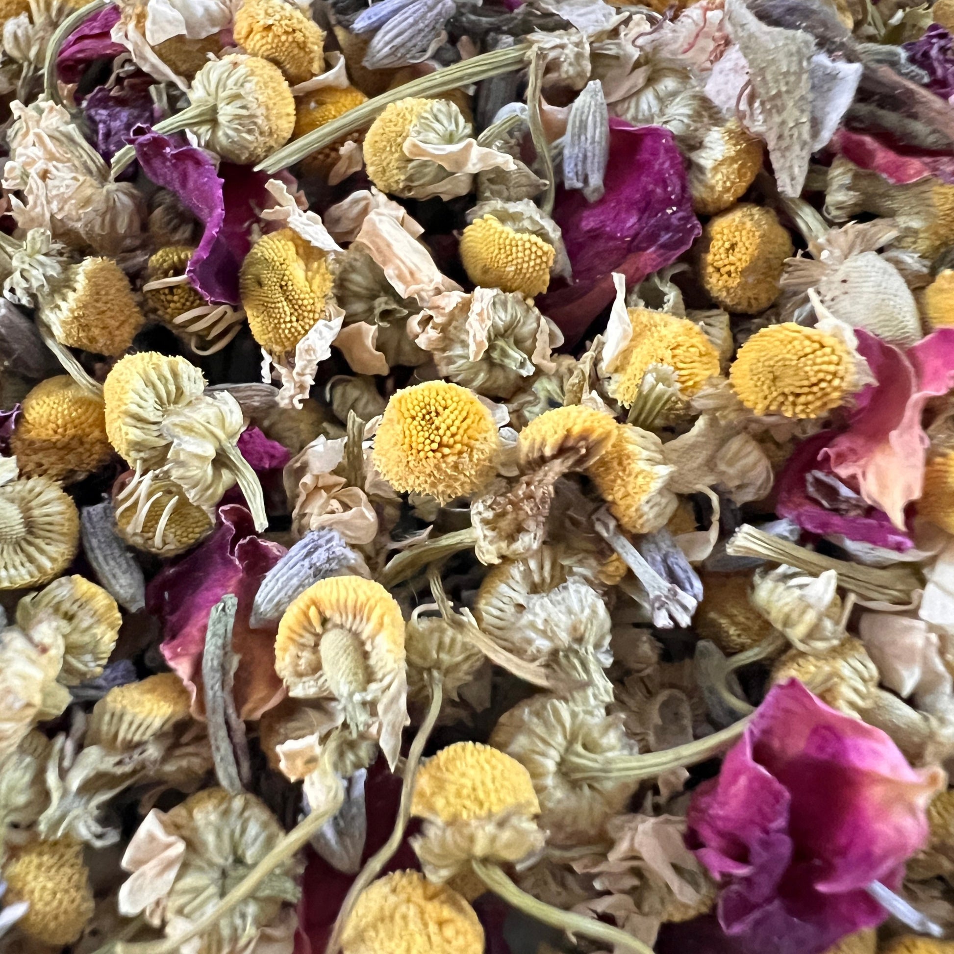 Close-up of chamomile, rose petals, and lavender tea