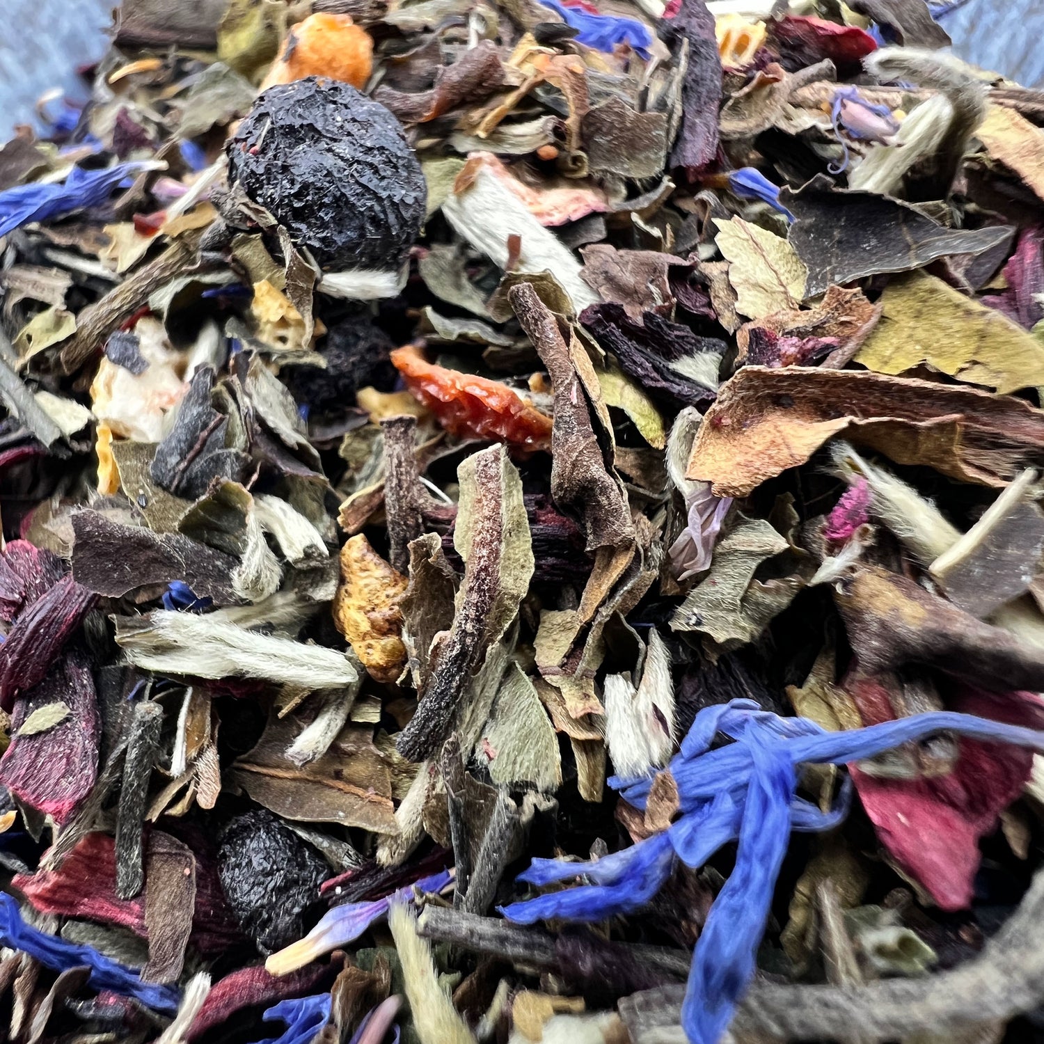 Assorted white tea, dried fruit and flowers in a bowl