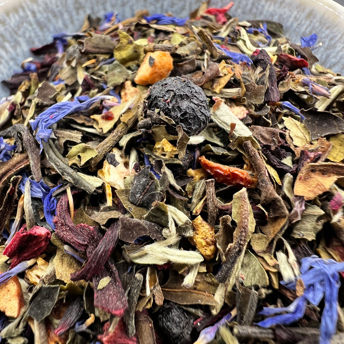 Assorted dried tea leaves and flowers in a bowl