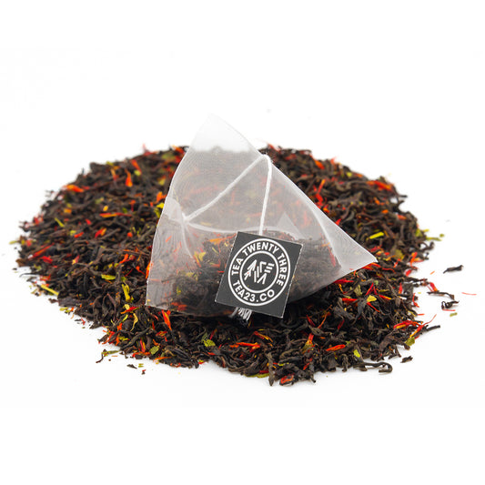 An Earl Grey pyramid tea bag sits on a pile of Earl grey Tea