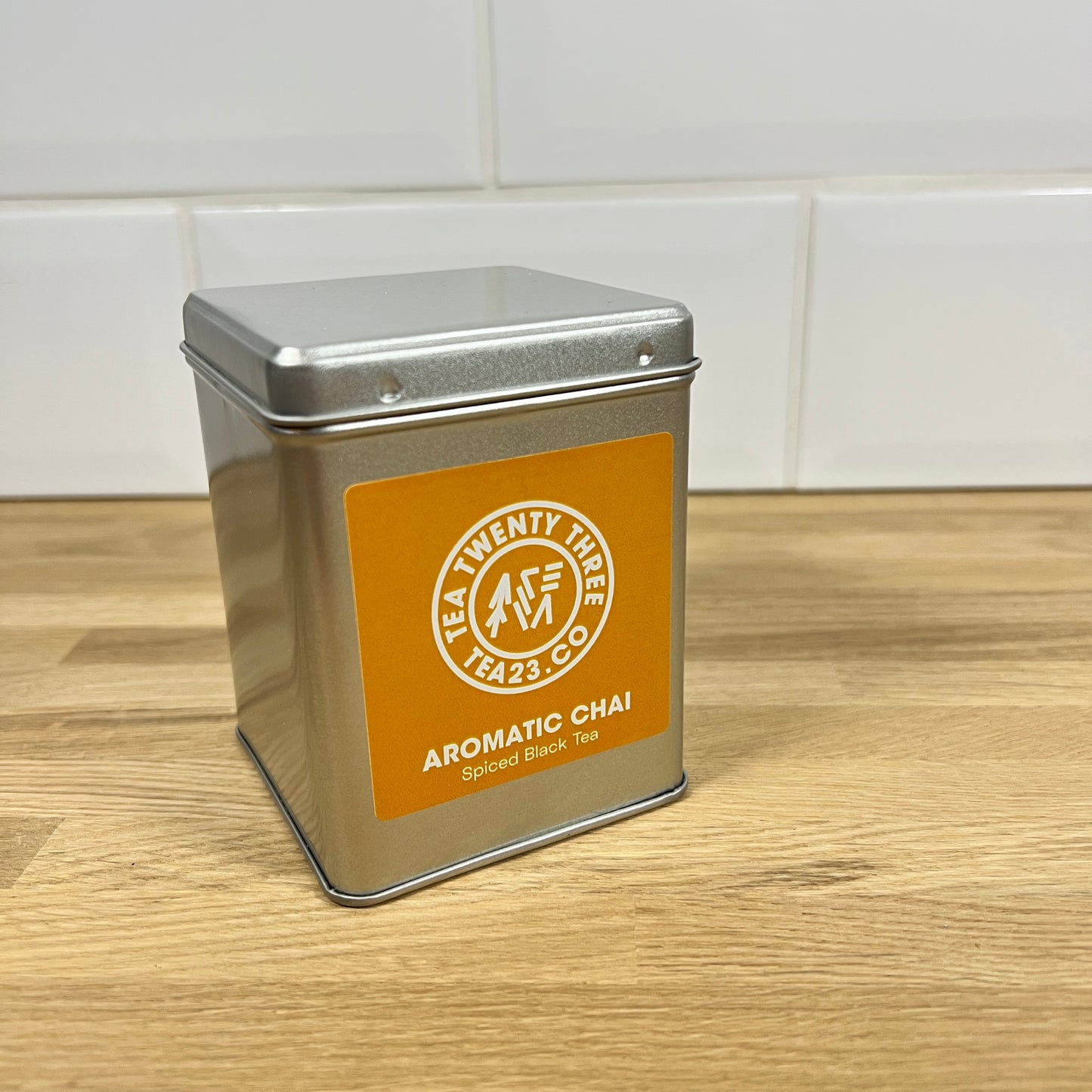 A silver tin of loose leaf Aromatic Chai Tea on a table