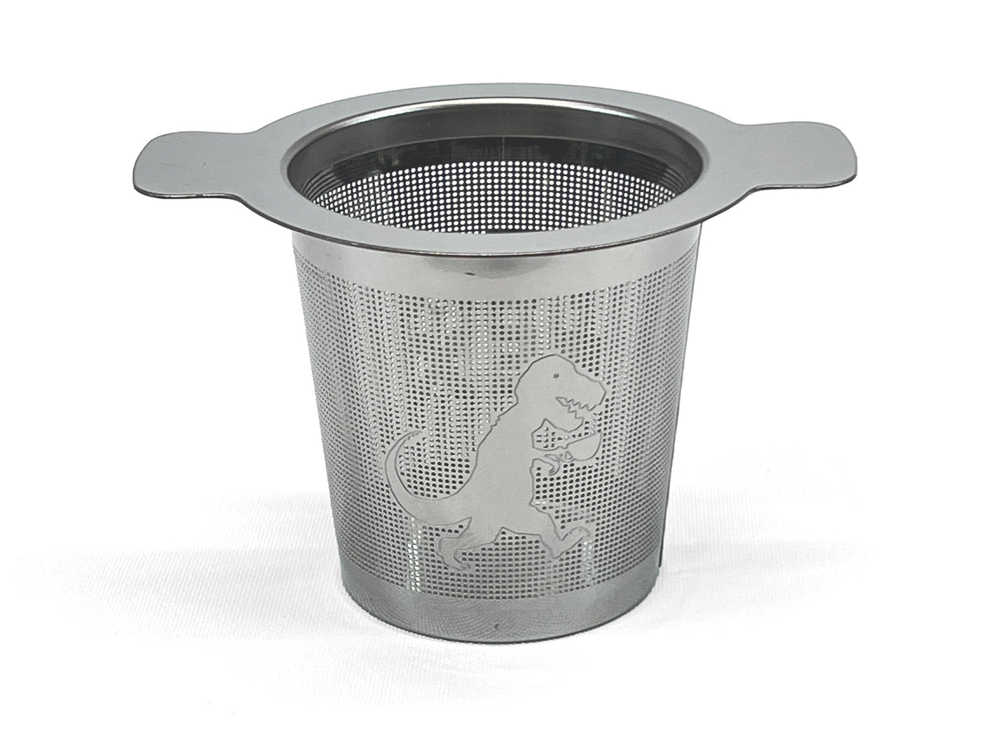 Front view of a stainless steel tea infuser with a T-Rex holding a cup of tea on it