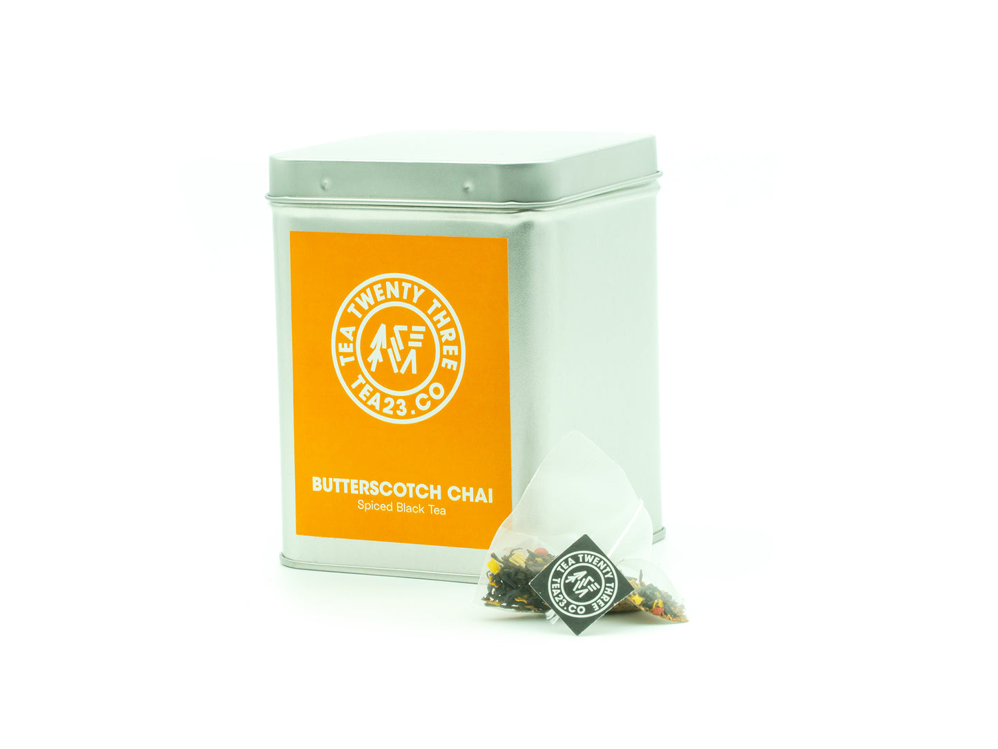An Aromatic Chai tea bag from TEA23 sits in front of a tea caddy from Tea23
