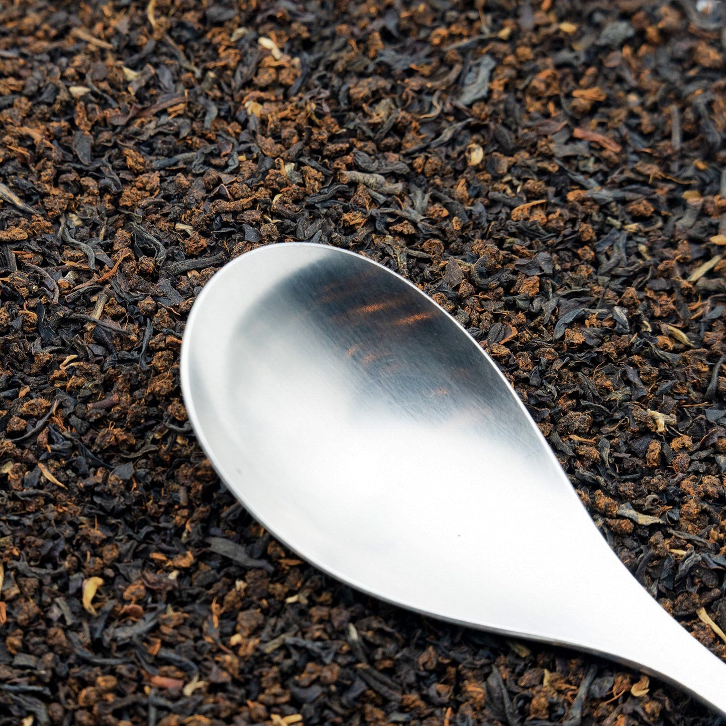 Loose leaf English Breakfast Tea with a spoon resting on top