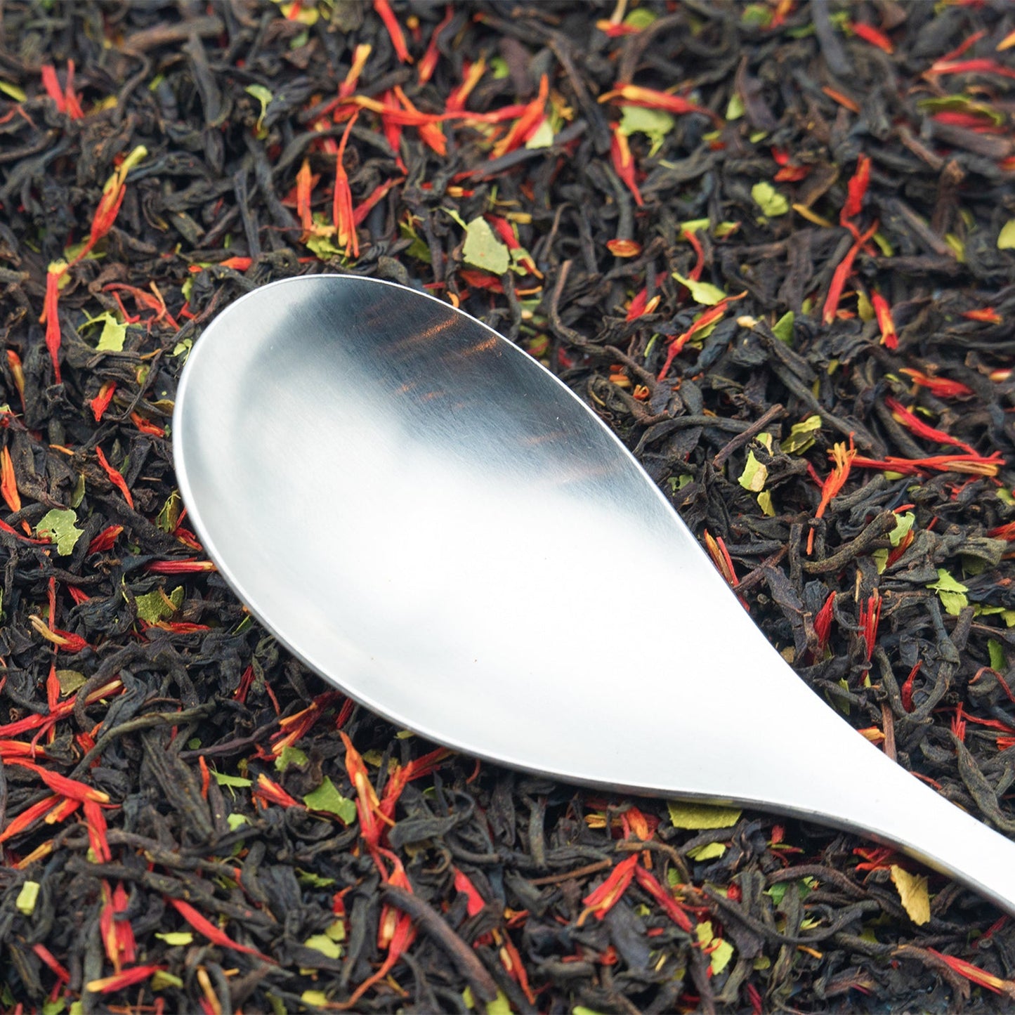TEA23 loose Earl Grey tea with a silver spoon resting on top
