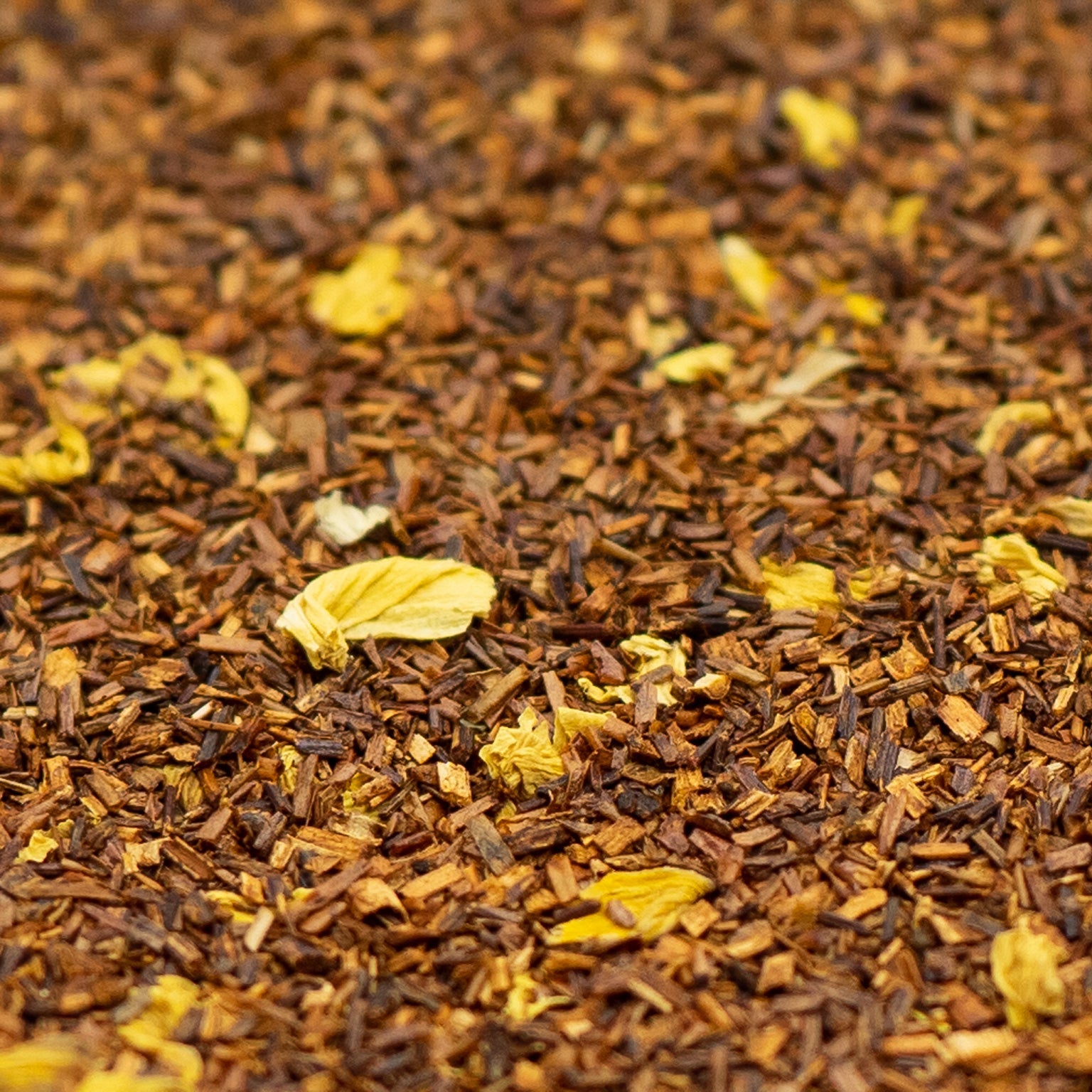 Pile of Rooibos tea with sunflower petals