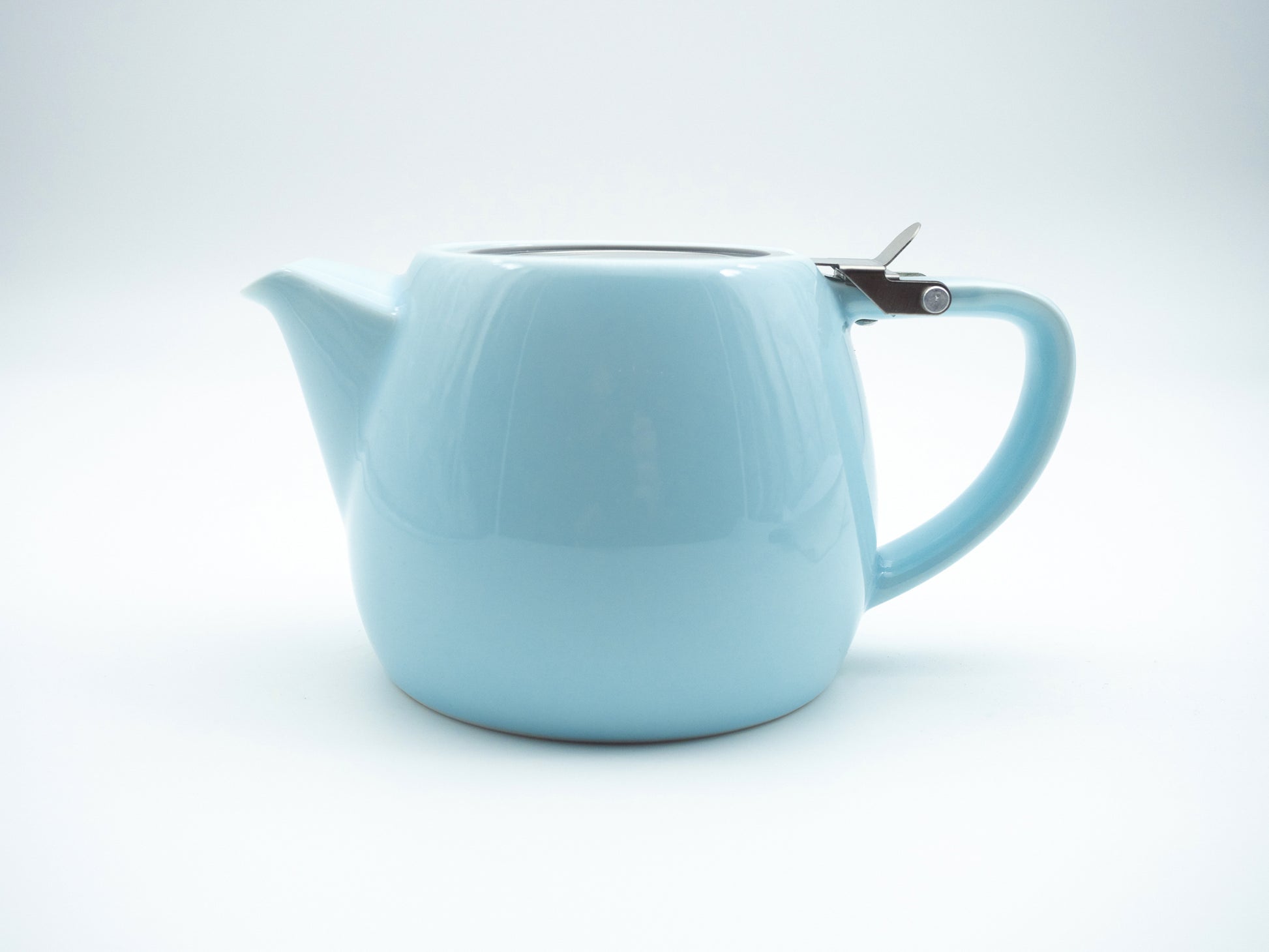 Side view of light blue porcelain stump tea pot