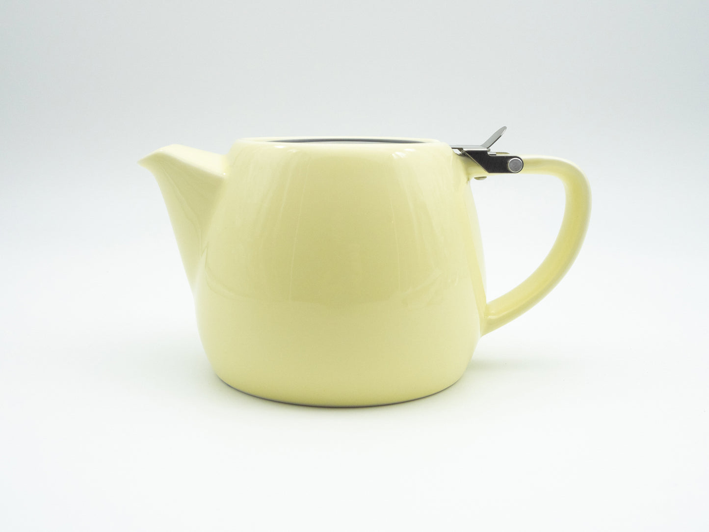 Side view of vanilla porcelain stump tea pot