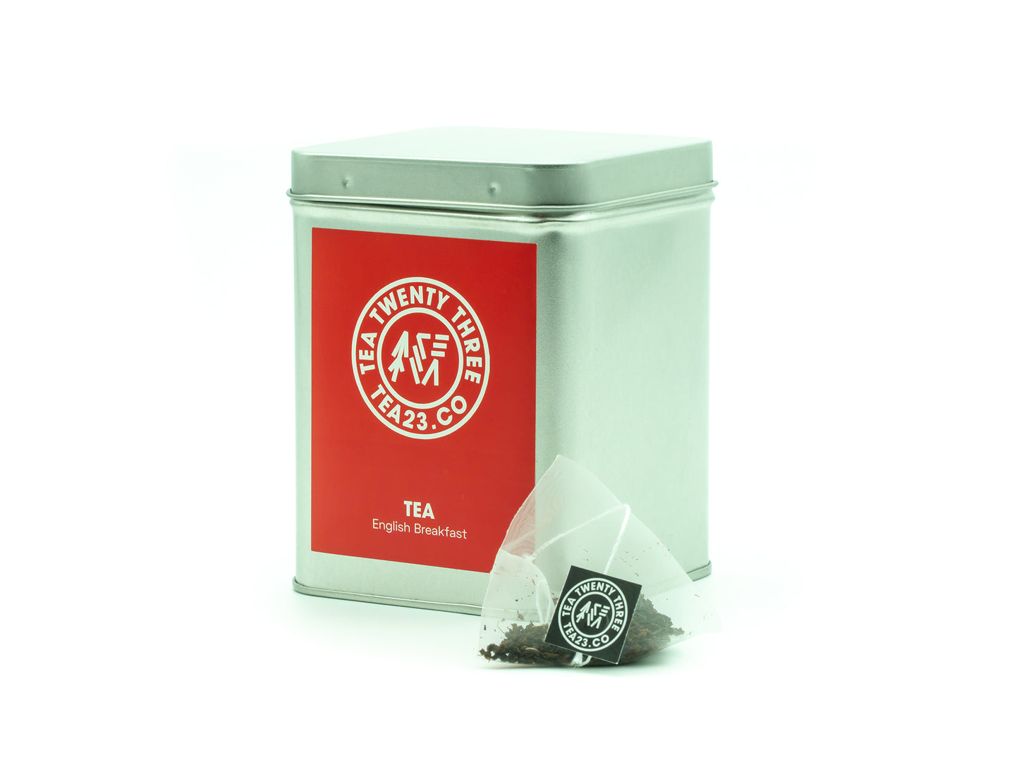 An English Breakfast Tea pyramid tea bag from Tea23 in front of a tea caddy
