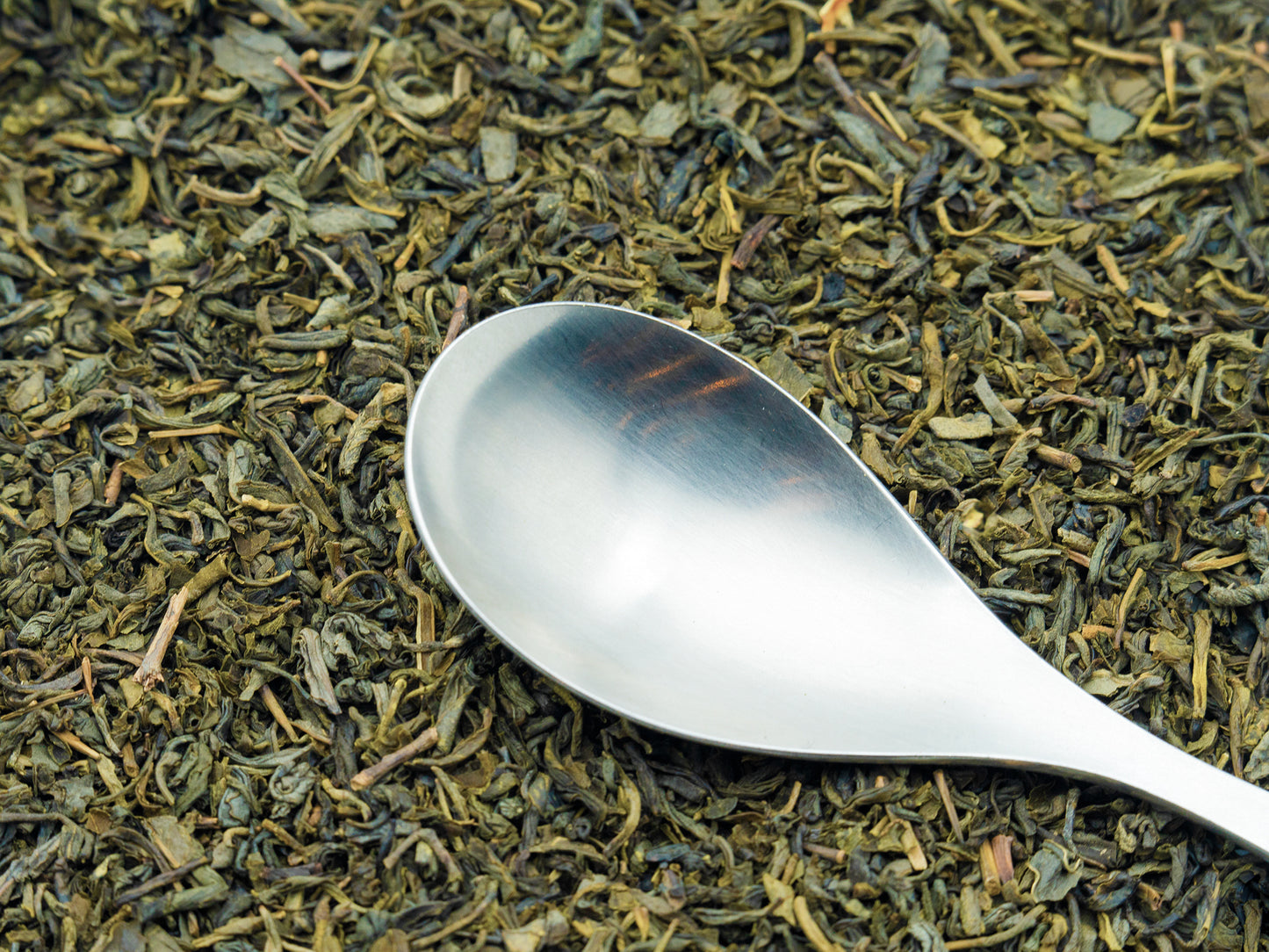 Loose Jasmine Green Tea from TEA23 with a spoon resting on top