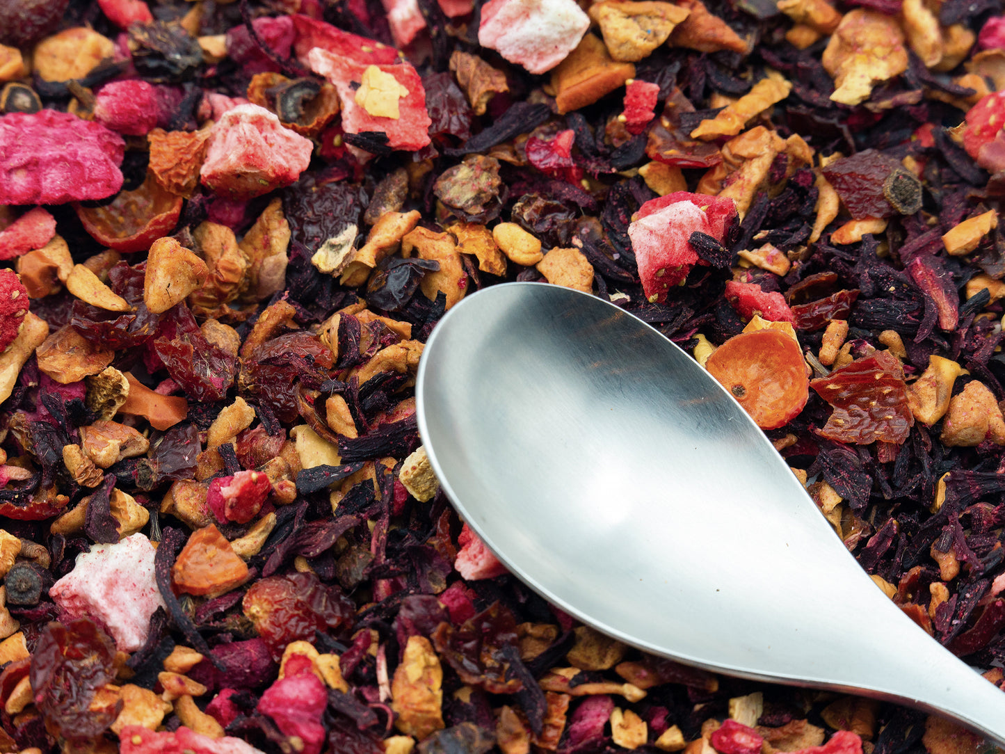 Red Berry loose fruit tea from TEA23 with a spoon resting on top