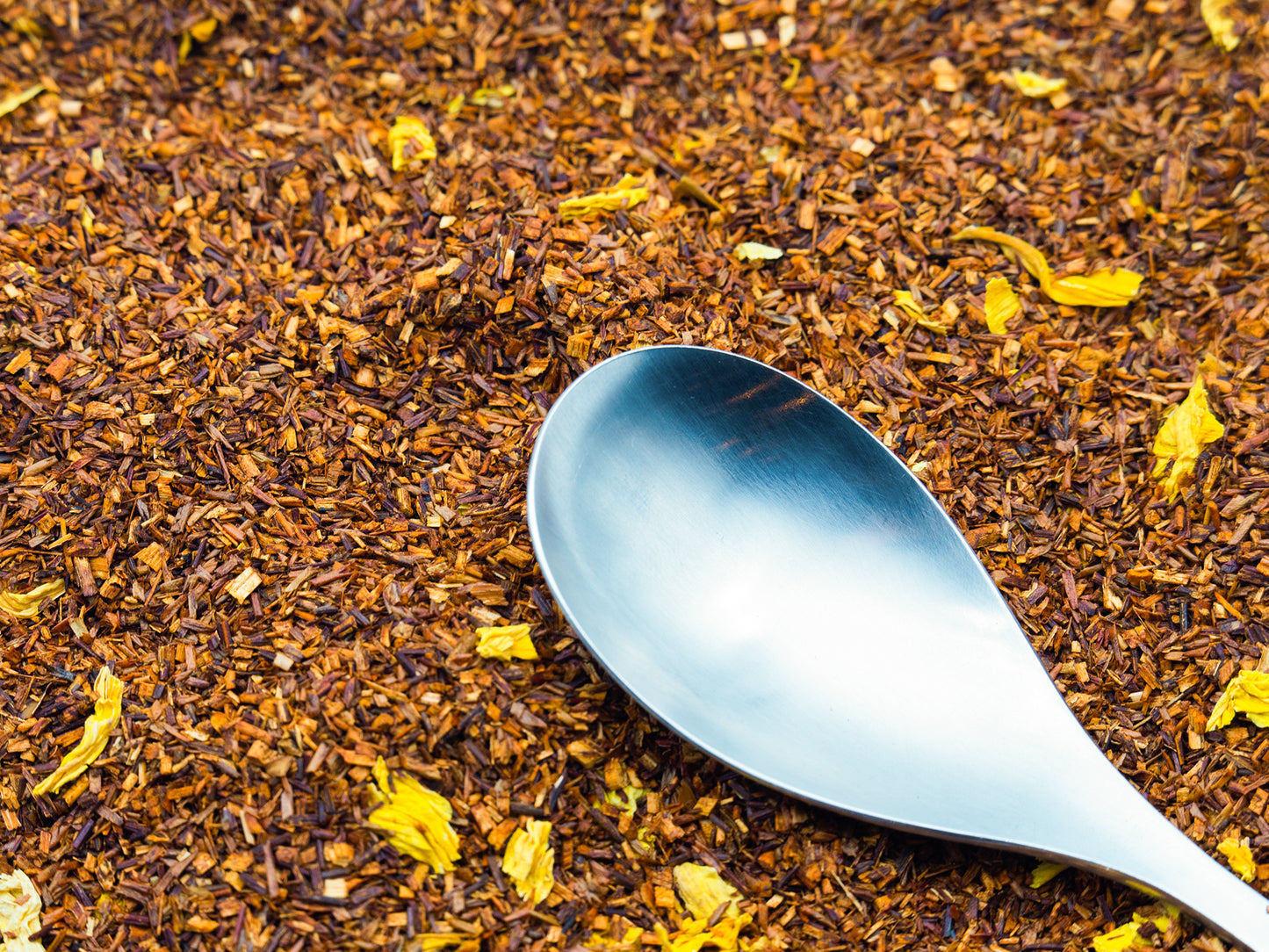 Loose Rooibos tea from TEA23 with a spoon resting on top